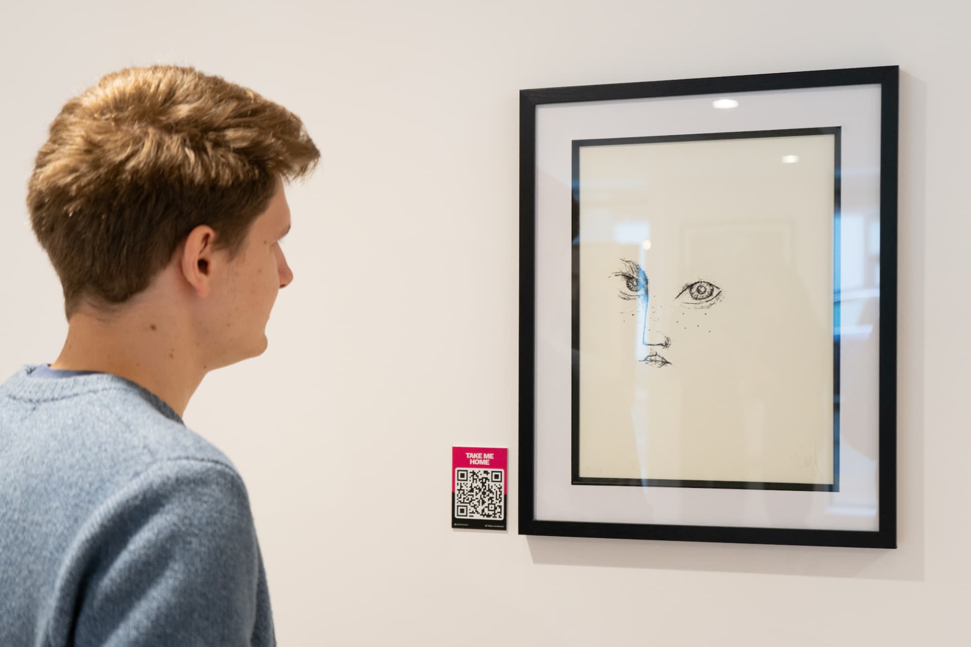 Visitors viewing curated artworks in a hospitality space