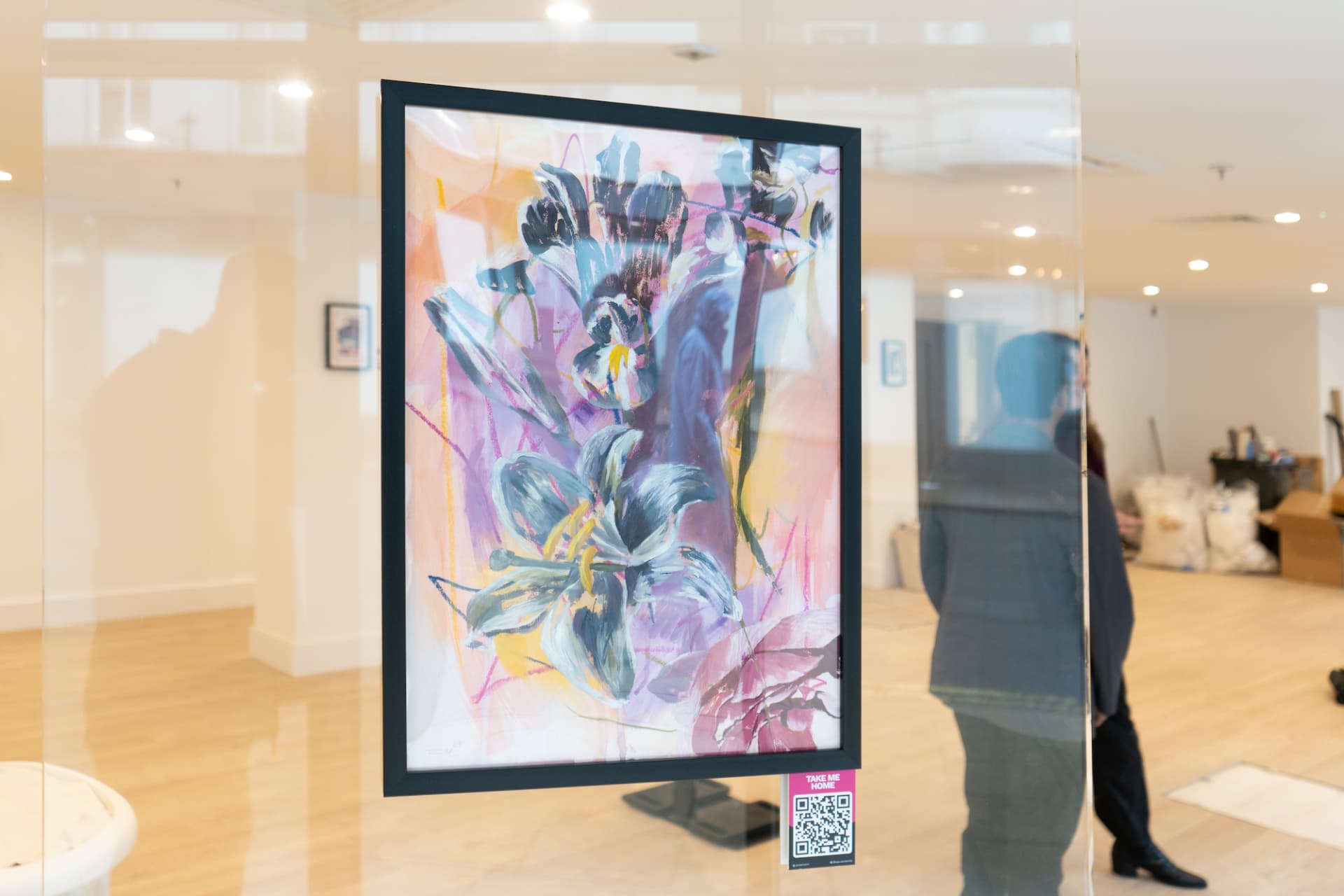 Guest viewing an artwork with a QR code label inviting them to learn more