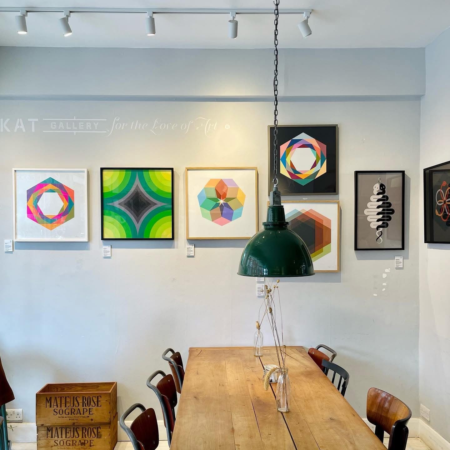 Local artists' work displayed on the walls of KAT Coffee in London