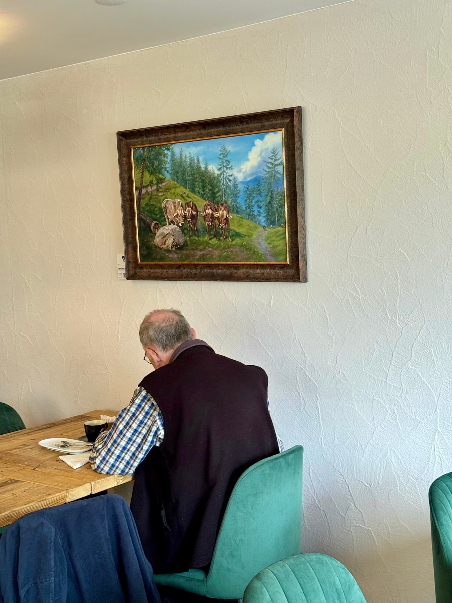 Curated original artwork placed on the wall of an independent cafe