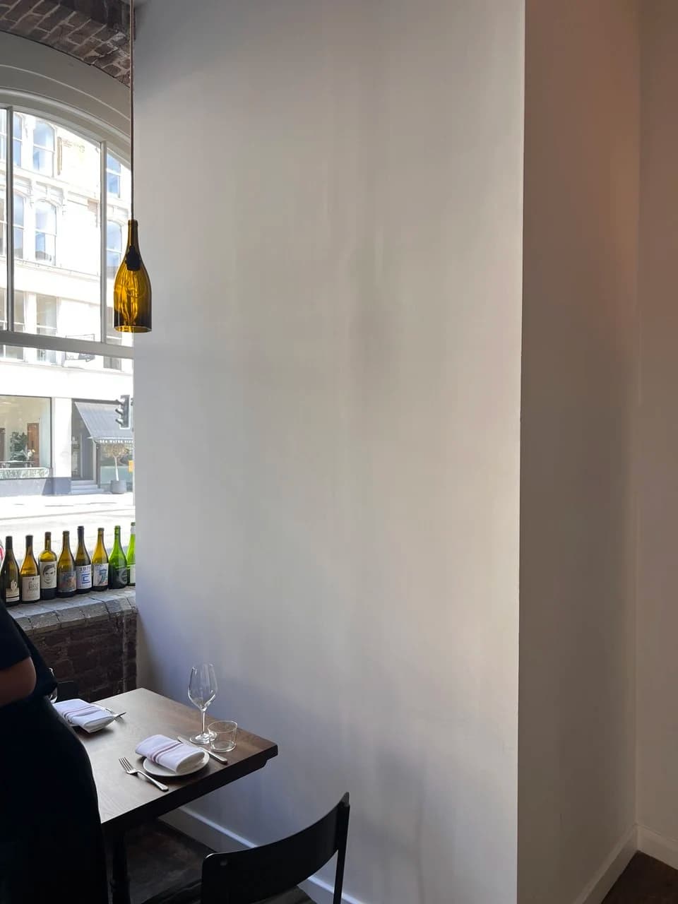 Empty white wall beside a window table at Lady of the Grapes, London Bridge
