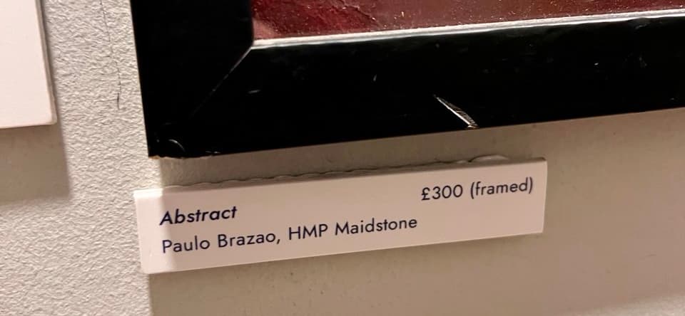 A price label beside an artwork that mentions the artist, the title and the price, but is missing contact details